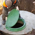 A,Worker,Installs,A,Sewer,Manhole,On,A,Septic,Tank